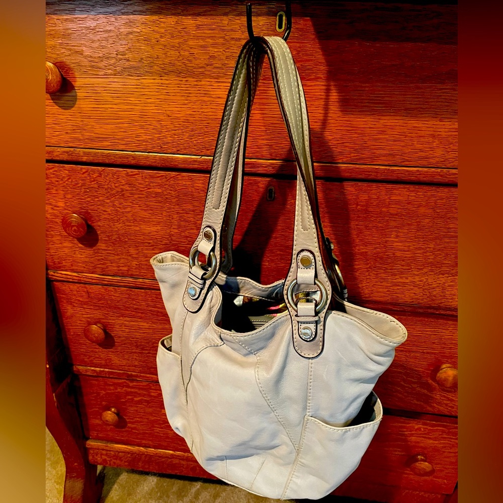 Great condition with clean divided interior. Has zippered compartments.